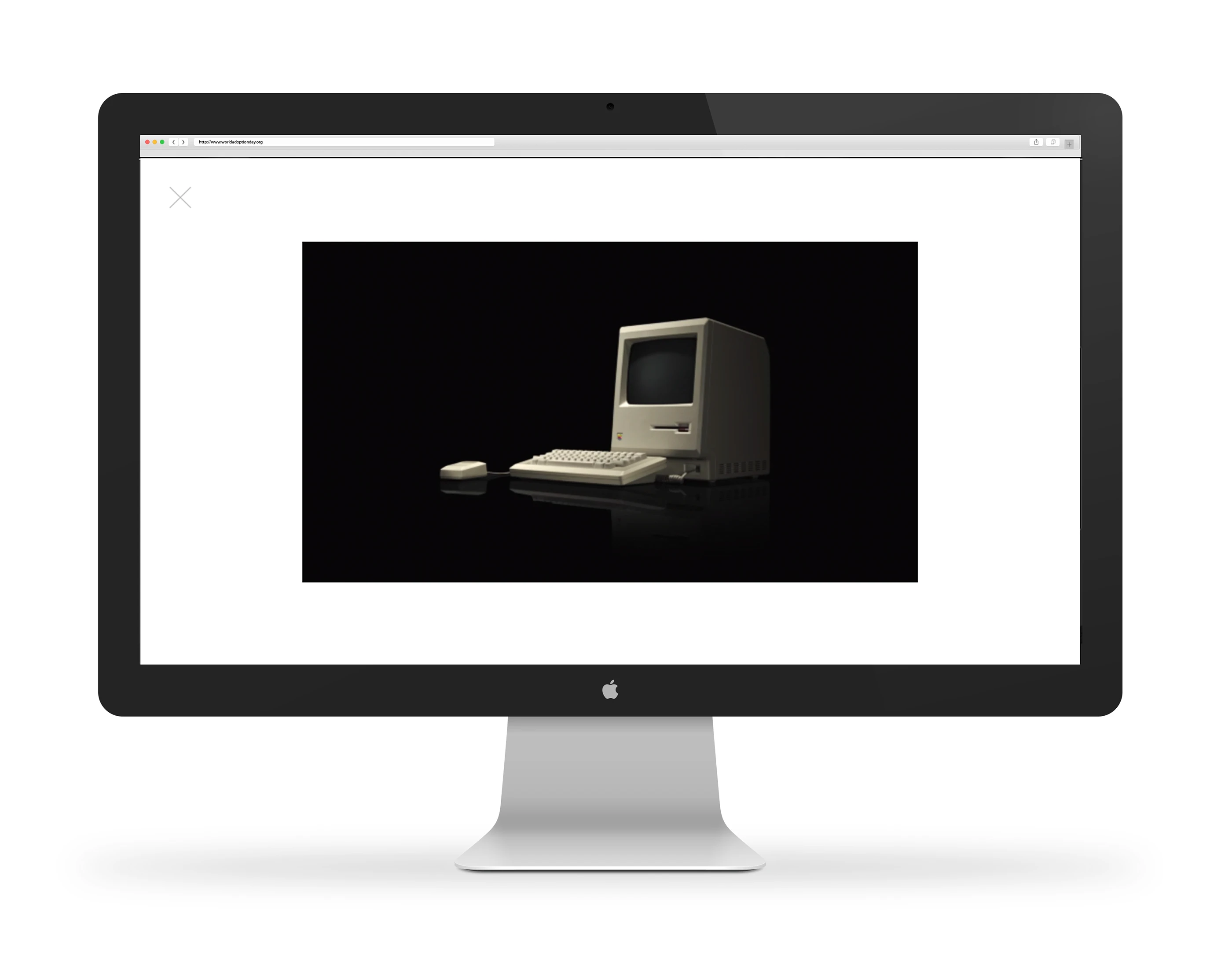 An original Macintosh on screen inside a modern display, from the Mac 30 anniversary site