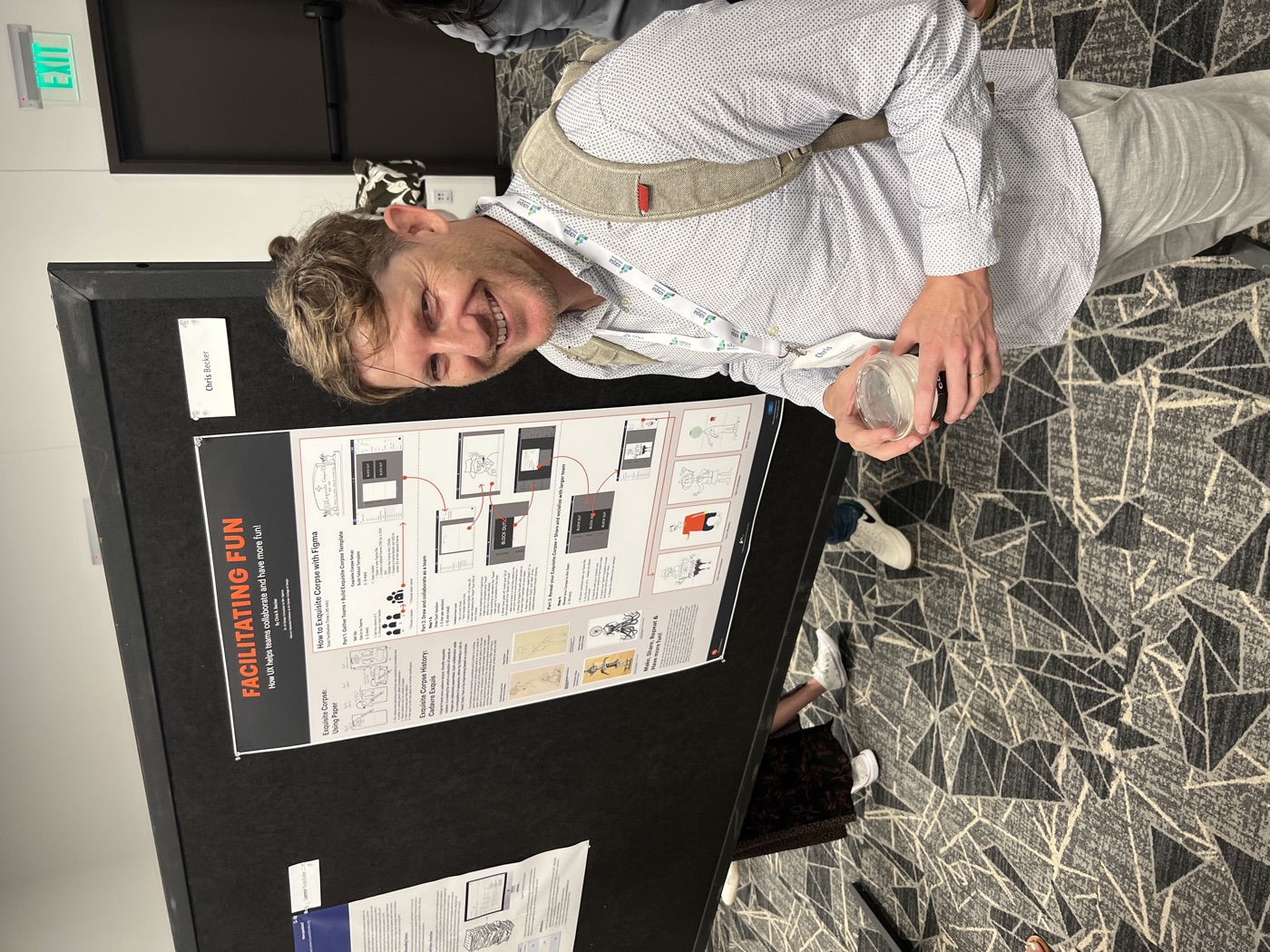 Chris standing next to the Facilitating Fun poster at the conference